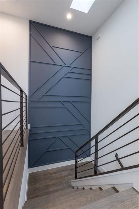 An Empty Room With Some Stairs And A Wall Painted In Shades Of Blue