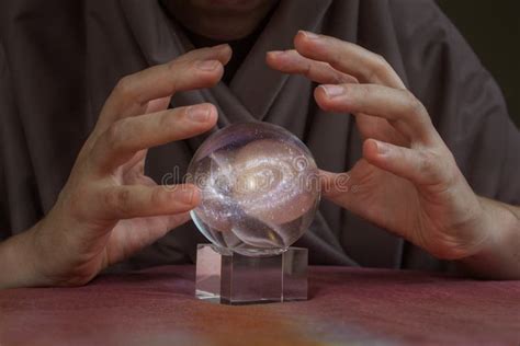 Hands Of Fortune Teller Over Magical Crystal Ball With Galaxy Elements