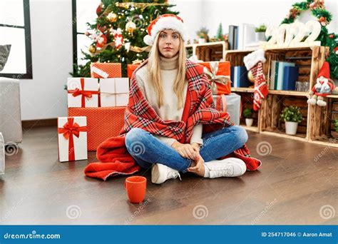 Beautiful Blonde Woman Sitting On The Floor By Christmas Tree With