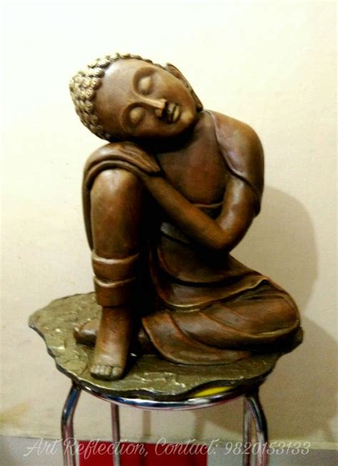 A Small Statue Sitting On Top Of A Stool