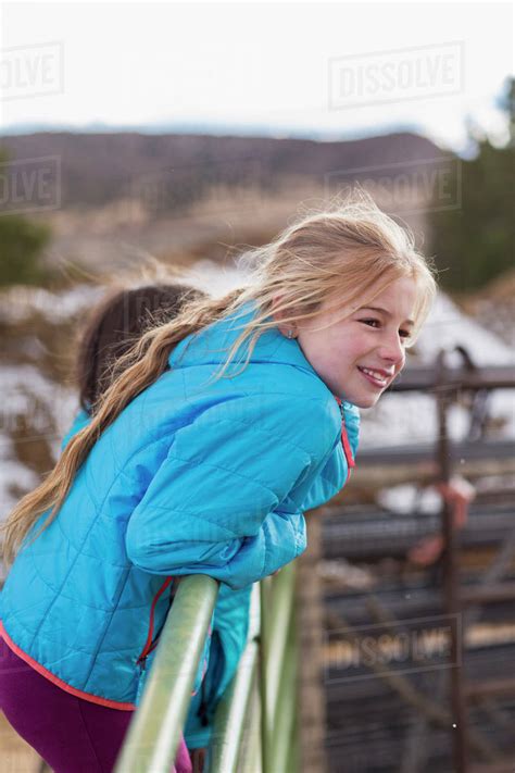 Caucasian Girl Standing On Fence On Farm Stock Photo Dissolve