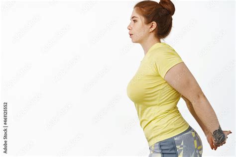 Portrait Of Redhead Chubby Woman In Fitness Clothing Stretching Arms