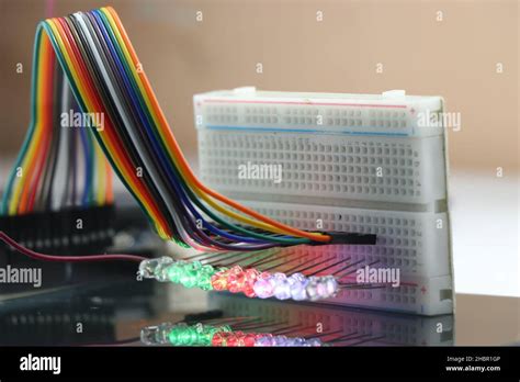 Breadboard With Glowing Lights From Led With Reflections On The Glass