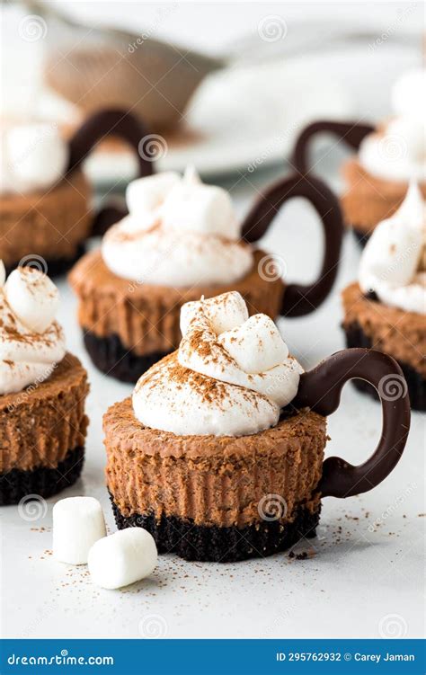 Mini Hot Cocoa Cheesecakes Topped With Whip Cream And Marshmallows