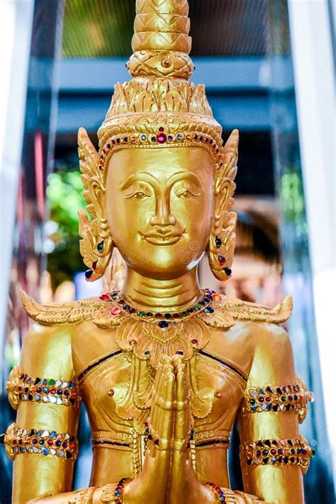 A Gold Statue Of A Woman With A Gold Crown And Gold Wings Editorial