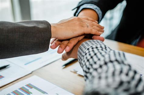 Premium Photo Midsection Of Business People Stacking Hands On Table