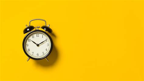 Black Alarm Clock On Yellow Background Desktop Wallpapers X