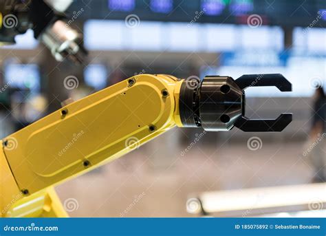 A Yellow Robotic Arm On A Blurry Background Stock Photo Image Of Line