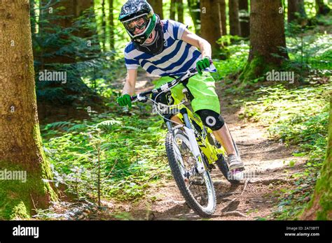 Mountainbike Riders Doing A Courageous Downhill On Forest Trails Stock