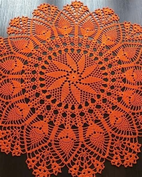 An Orange Doily On A Wooden Table