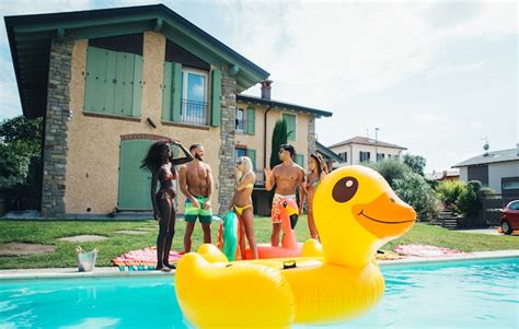 Premium Photo Group Of Friends Having Fun In The Swimming Pool