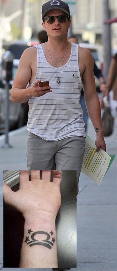 a man with a tattoo on his arm walking down the street