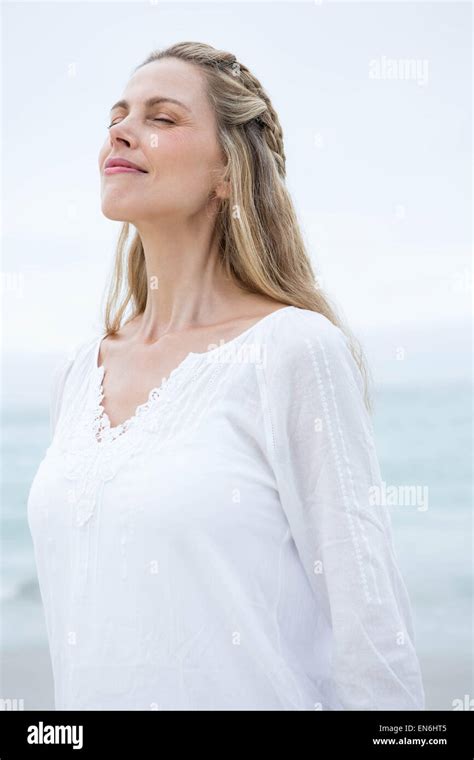 Smiling Pretty Blonde Standing By The Sea Stock Photo Alamy