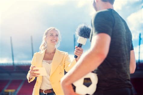 Reporter Interviewing Football Player In A Stadium Stock Photo Image