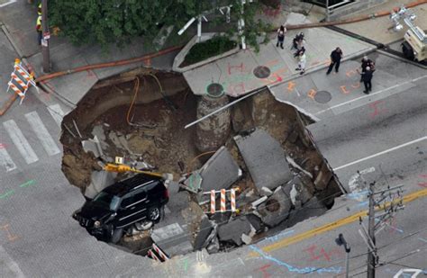 Miraculous Escape For Driver As Car Falls 20ft Into Sinkhole At Traffic