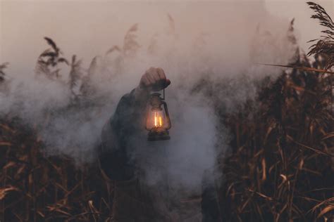 Person Holding Kerosene Lantern · Free Stock Photo