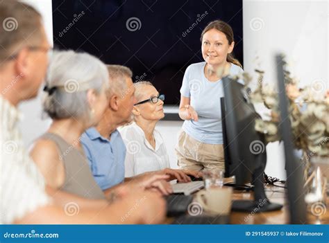 Female Tutor Teaching Group Of Seniors In Computer Workshop Stock Image