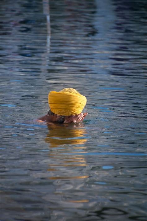 Sikh Man Praying In The Holy Lake At Golden Temple Amritsar India