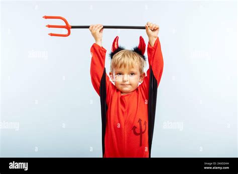 Cute little boy in devil halloween costume with horns and trident Stock ...