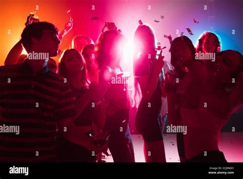 Wild A Crowd Of People In Silhouette Raises Their Hands Dancing On