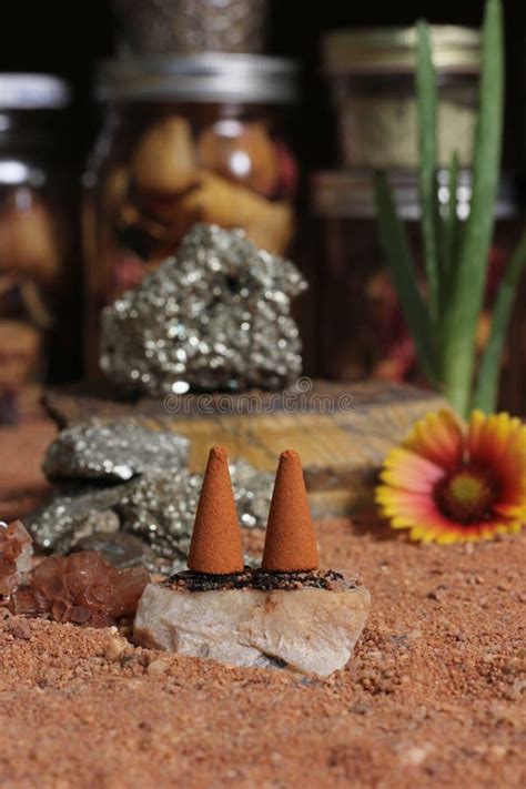 Aragonite Crystal With Incense Cones On Australian Red Sand Stock Photo