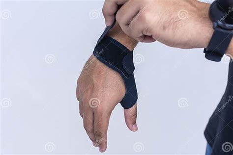 A Man Adjusts The Straps Of An Ultra Thin Compression Wrist And Thumb