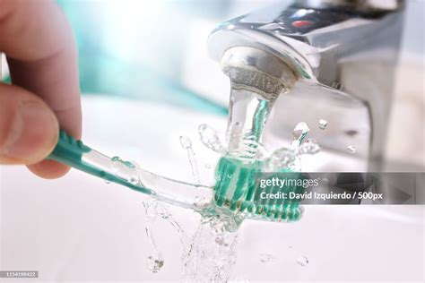 Daily Cleaning Of The Toothbrush After Use In Sink Detail High Res