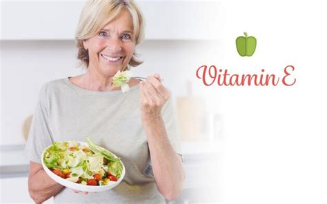 Premium Photo | The word vitamin e against smiling woman eating salad