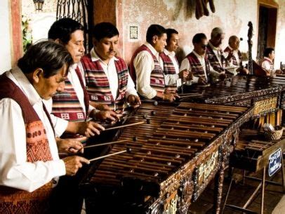 A Group Of Men Standing Next To Each Other In Front Of Musical Instruments