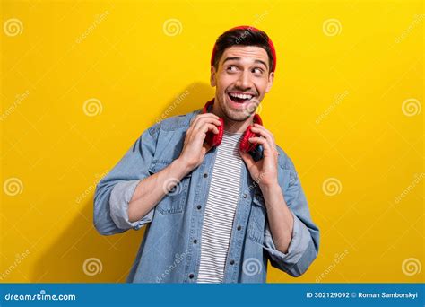 Photo Of Excited Funky Man Dressed Jeans Shirt Listening Song Earphones Looking Empty Space