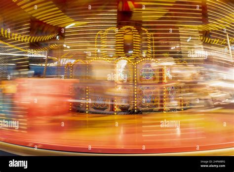 Long Exposure Of A Colourful Spinning Carousel Fairground Ride Stock