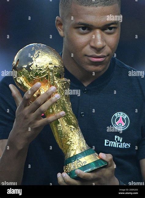 Paris Saint Germains Forward Kylian Mbappe Lifts The 2018 World Cup Trophy Prior To The French