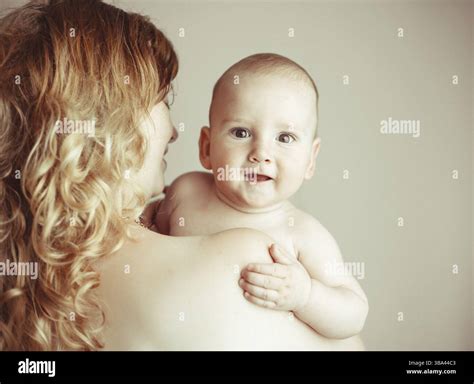 A Natural Blonde Caucasian Mother Kissing Happy Baby Stock Photo Alamy