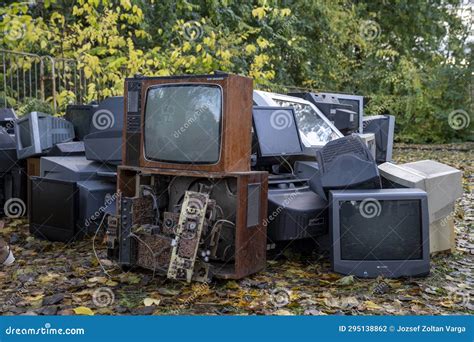 Electronic Waste Awaiting Recycling A Pile Of Garbage In Nature Green