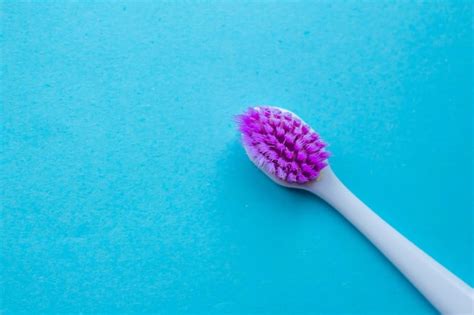 Premium Photo A Purple And White Brush With A Purple Handle Sits On A