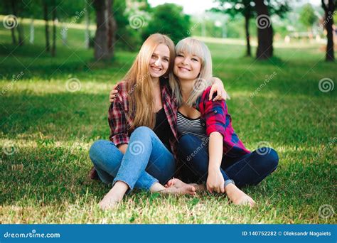 Lifestyle And People Concept Two Young Girl Friends Sitting Together