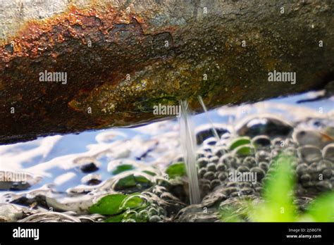 Water leak or breakthrough rusty pipe Stock Photo - Alamy