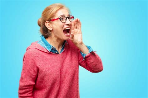 Premium Photo Beautiful Adult Blonde Woman Shouting Loud Like Crazy Calling With Hand With An