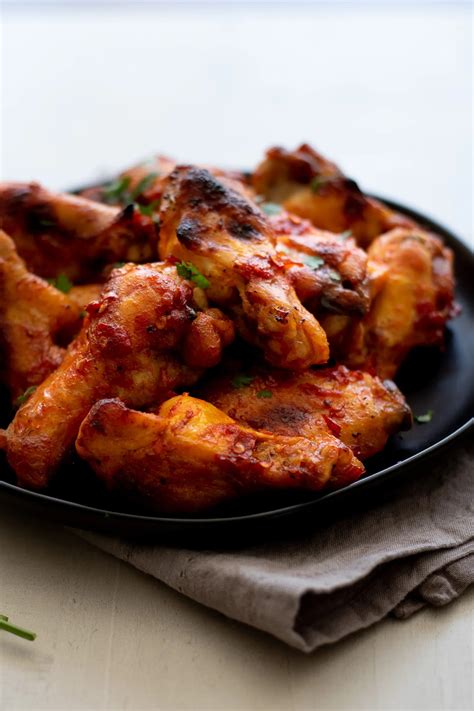 Honey Harissa Chicken Wings With Two Spoons