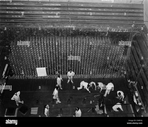 Workers laying up the graphite core of the Reactor-B atomic pile. The ...