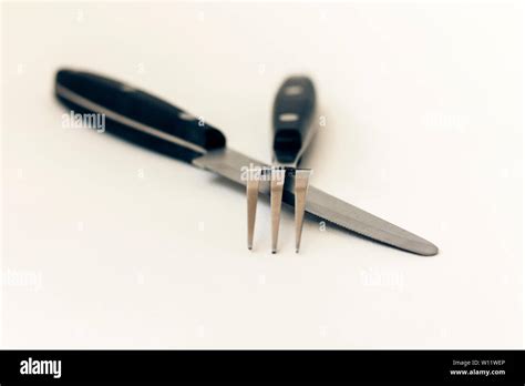 Close Up Knife And Fork Crossed Isolated On White Background Stock