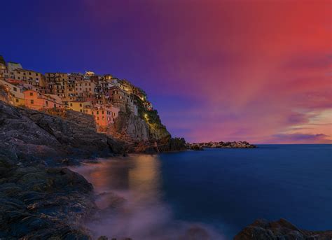 Cinque Terre colorful traditional houses on a rock over Mediterranean sea after sunset at the ...