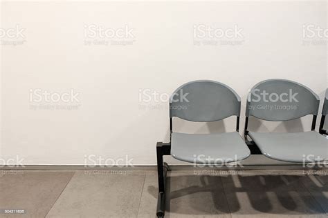 Two Empty Chairs By Concrete Wall With Copyspace Stock Photo Download