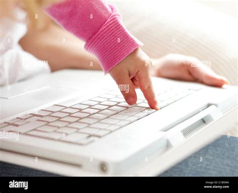 Child typing on keyboard Stock Photo - Alamy