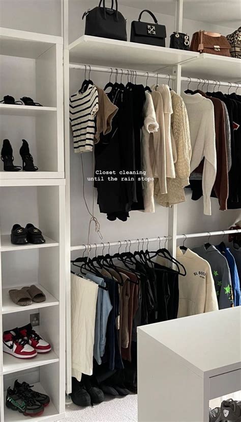 A White Closet Filled With Lots Of Clothes And Handbags On Top Of