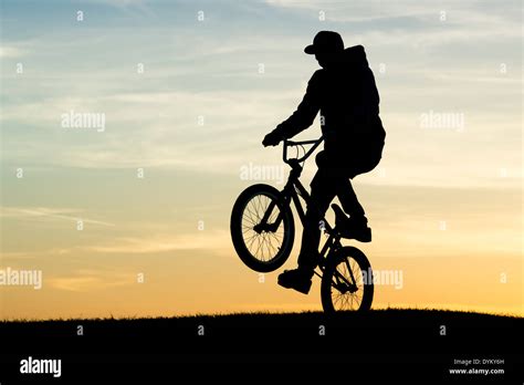 Young Man Doing A Wheelie On His BMX Silhouette Stock Photo, 42% OFF