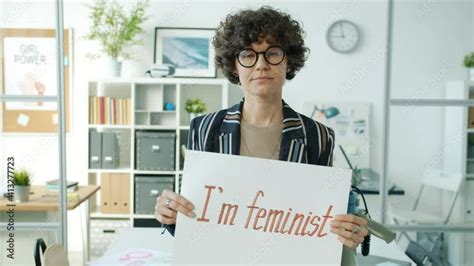 Portrait Of Confident Girl Feminist Holding Gender Equality Banner And Looking At Camera