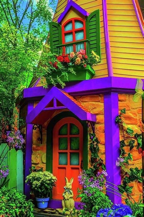 A Colorful House With Flowers And Plants On The Front