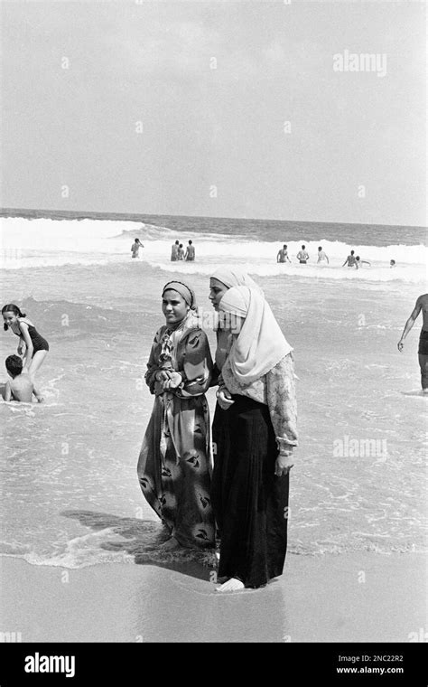 Egyptian Girls In Traditional Islamic Dress Stroll Barefoot Through The