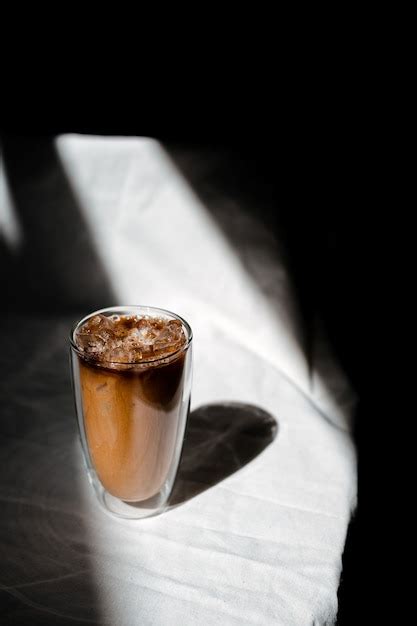 Premium Photo Glass Of Iced Coffee With Milk On The Table